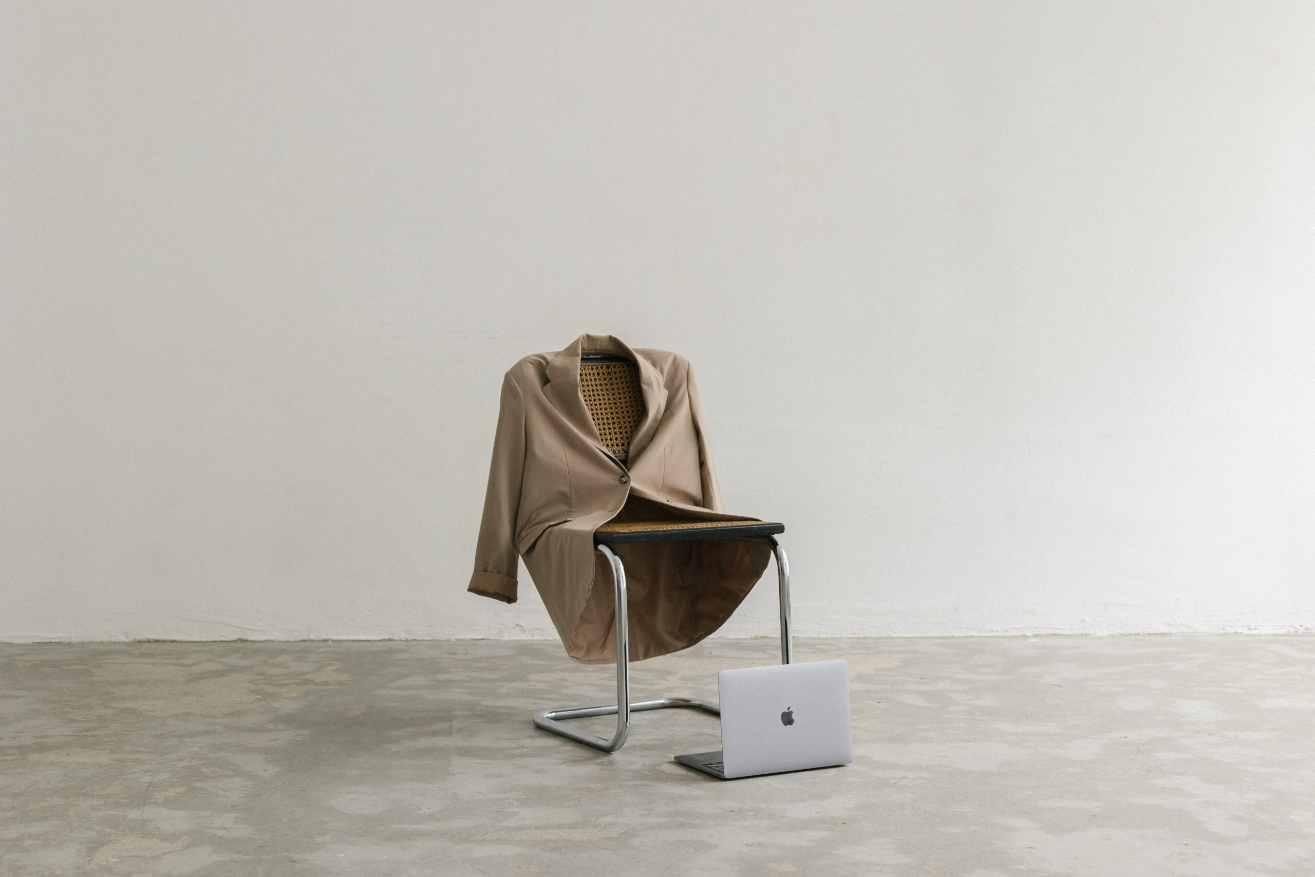 Chair with suit jacket and Macbook