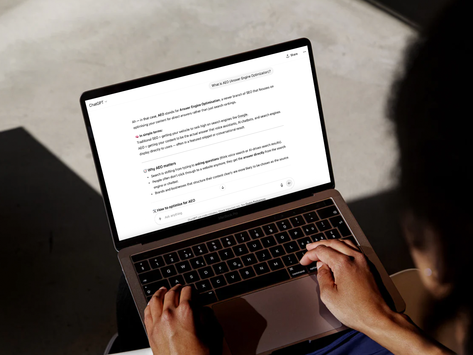 Woman with a Macbook, having ChatGPT open